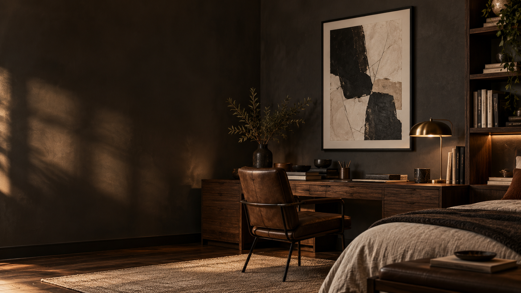 Moody walnut home office with black-framed abstract artwork and warm lighting